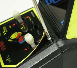 File:Coleco Pac-Man Mini-Arcade hood screw under control panel sticker.jpg