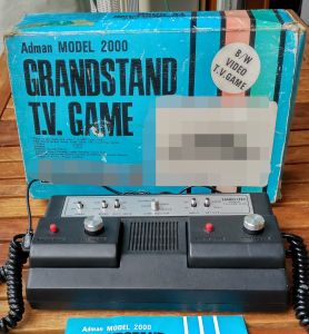 The console in front of its box, with the instruction leaflet at the bottom